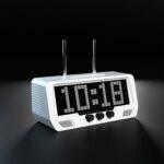 The Audio Visualizer Pro, a white clock radio, displays 10:18 on a black screen. Three audio dials below the LED display highlight its sleek digital interface.