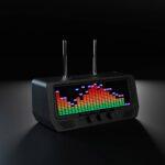 The Audio Visualizer Pro is a black retro-style radio with dual antennas, three control dials, VU meters, and a vibrant LED equalizer display on a dark background.