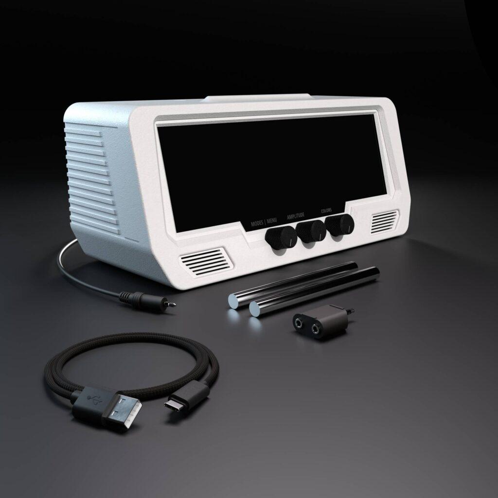 The Audio Visualizer Pro is a white rackmount unit with a large LED display, rotary encoders, input/output jacks, and patch cables neatly arranged in front.