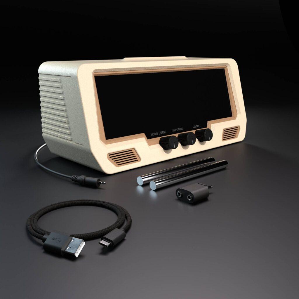 The Audio Visualizer Pro, a beige audio interface with a black display, three rotary encoders, four control switches, is shown alongside patch cables and adapters on a black background, providing intuitive signal controls for easy operation.