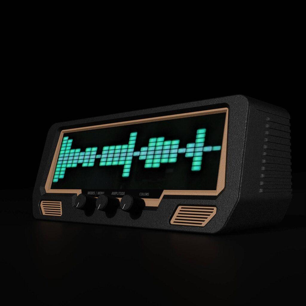 The Audio Visualizer Pro is a retro-style device with EQ sliders, rotary control knobs, vintage VU meters, and a green waveform display.