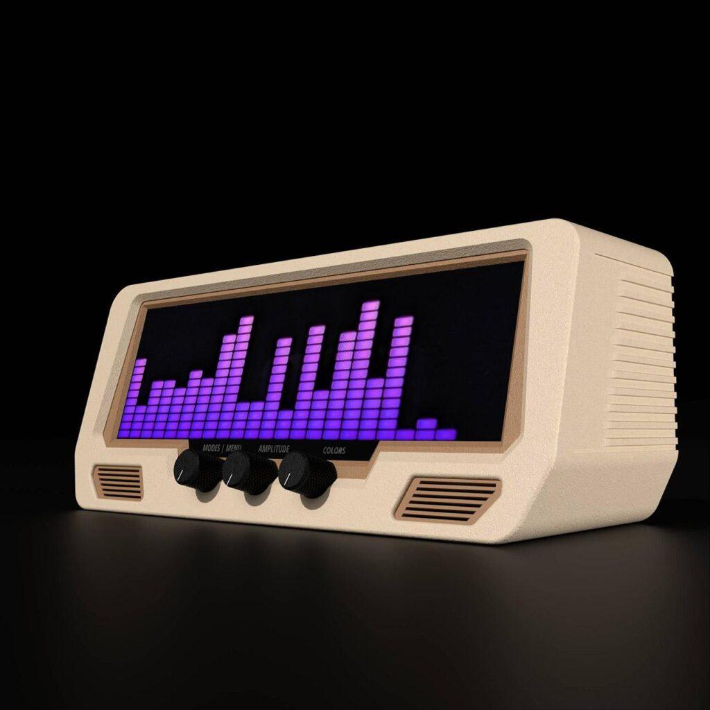 The Audio Visualizer Pro is a beige retro-style unit with a digital VU meter, purple LED equalizer, three rotary dials, and analog accents.