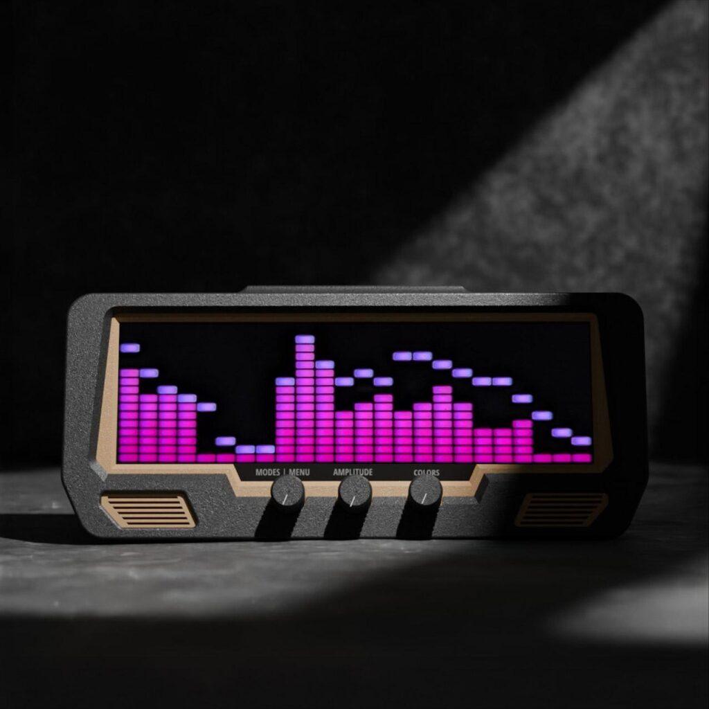 The Audio Visualizer Pro, with a black chassis, displays purple LED sound wave bars on its LCD panel atop a gray studio rack.