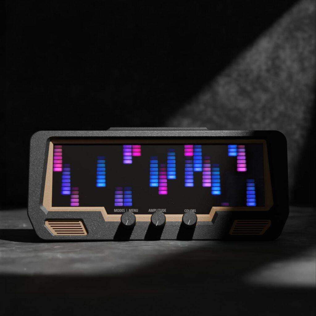 The Audio Visualizer Pro is a rackmount unit with a digital LED display showing blue and purple VU bars, plus three rotary dials: Modes | Menu, Amplitude, and Colors.