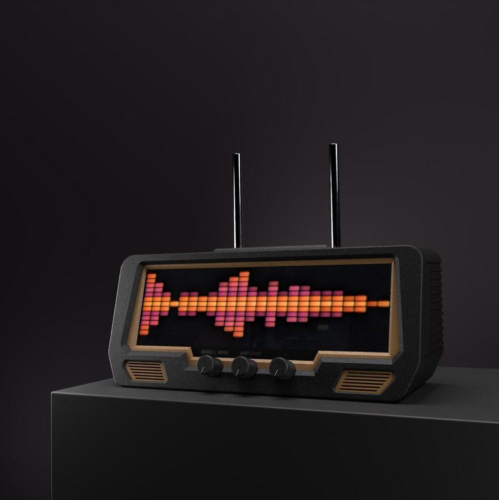 A modern radio tuner with dual antennas and three control dials features vibrant audio spectrum graphics on its LED display, set against a dark background.