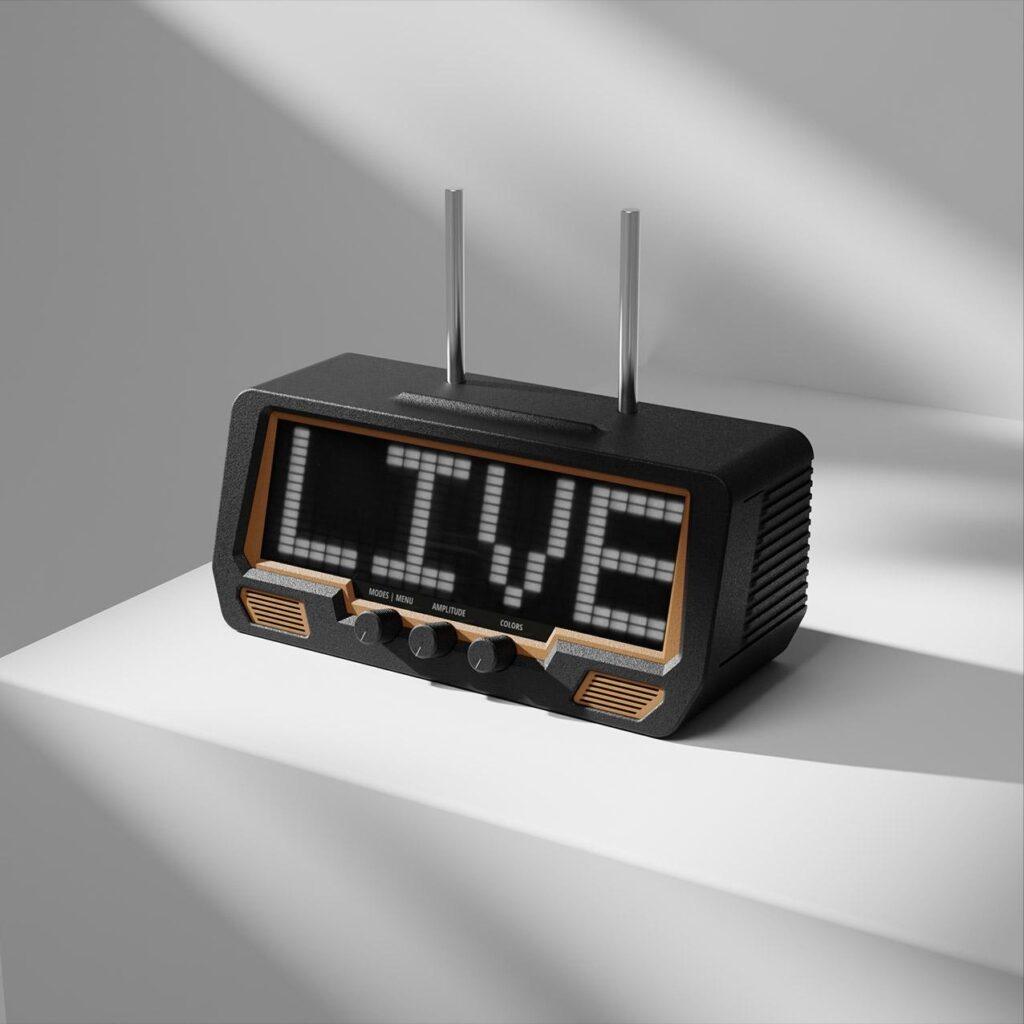 A vintage radio with built-in speakers and knobs shows LIVE on its digital display, set on a white surface with diagonal shadows.